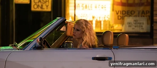 MaXXXine (2024) Film Review: A Dark Return to the Spotlight 2 Mia Goth with heavy eye make up and thick blonde hair, drives a convertible chevy right to left against the backdrop of harsh lighting.