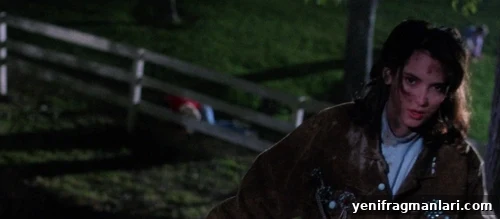 10 Iconic Heathers Moments You Can't Miss 4 Winona Ryder in a farm field at night.