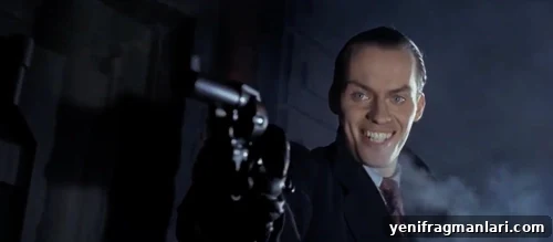 10 Iconic Batman Moments That Shaped the Dark Knight 2 Jack Nicholson smiling maniacally and toting a gun in 'Batman' (1989).
