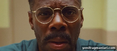 Colman Domingo, wearing gold glasses and staring directly into camera in the film 'Sing Sing'.