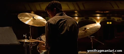 How Whiplash Reveals the Cost of Perfection 2 Miles Teller sat at a drum set in the 2014 feature film 'Whiplash'.