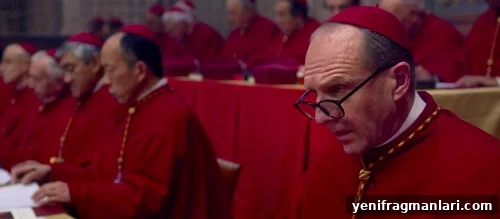 Ralph Fiennes in red Catholic attire for 2024 Edward Berger feature film 'Conclave'.