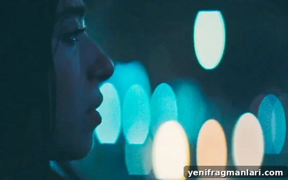 Joseph Wade's Top 10 Films of 2024 7 Mikey Madison against the blurred backdrop of a city in the 2024 feature film 'Anora'.