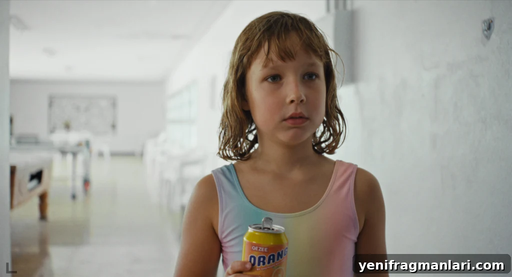 Everytime Review: Grief, Memory, and a Hidden Glimmer 4 A young girl with wet hair holds a can of orange soda in a bright white hallway in Everytime.