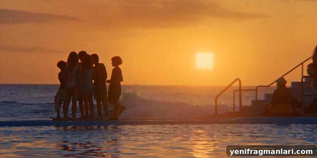 Everytime Review: Grief, Memory, and a Hidden Glimmer 5 A group of people gather beside a swimming pool at sunset, silhouetted against a glowing square sun in Everytime.